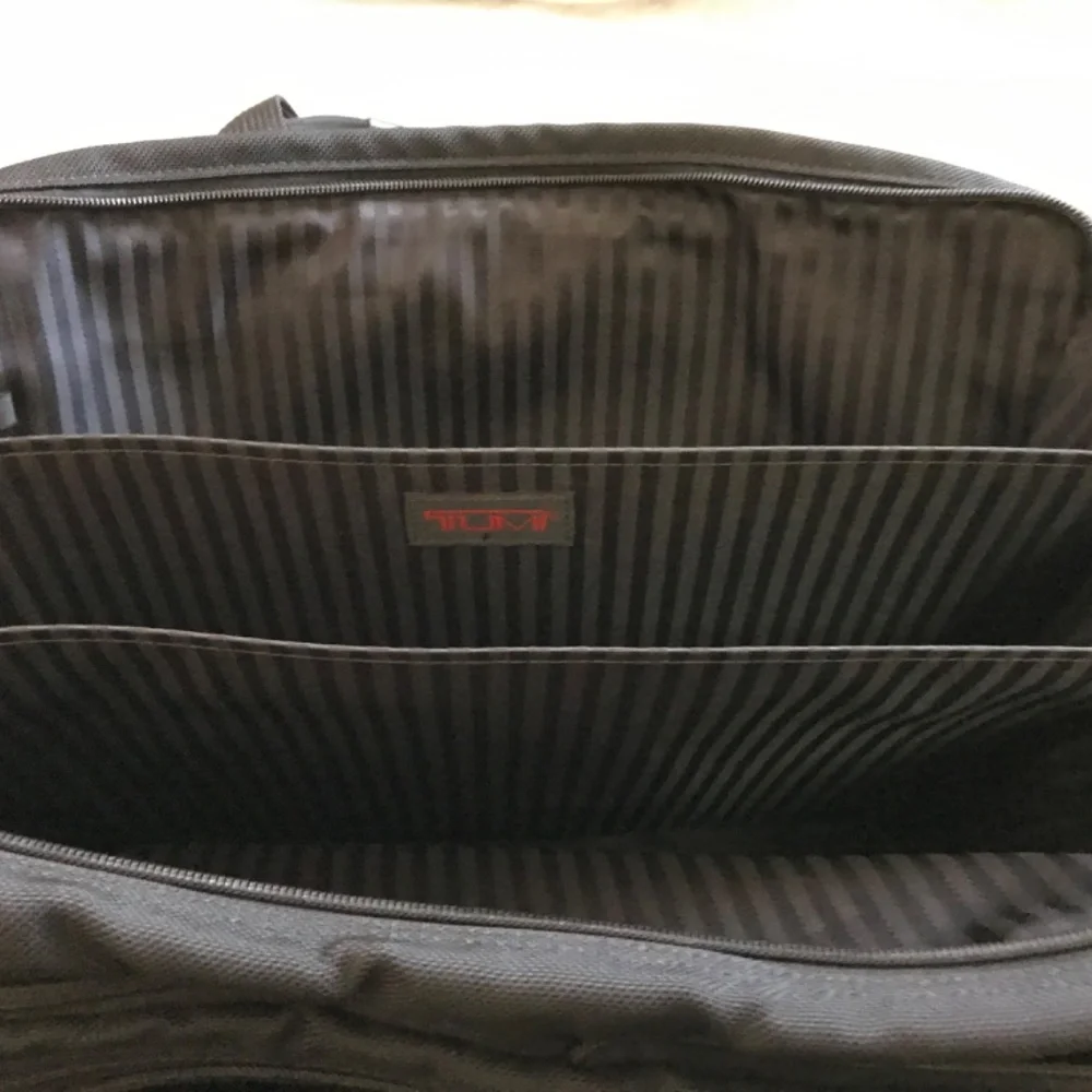 Tumi Black expandable laptop bag. clean interior. Work, travel, Classic